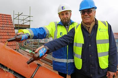 Richard Dove left and Darryl Cox top out the new affordable homes at Roughton
