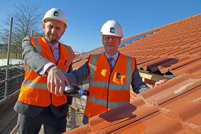 Richard Dove left and John Archibald celebrate the topping out of new sheltered accommodation at Portalfield in Stalham