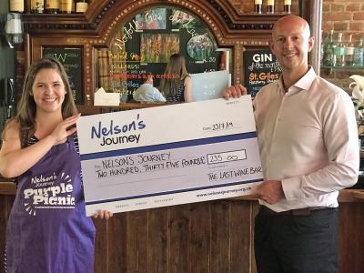 Sarah Dodge of Nelsons Journey receives the Purple Pudding cheque from Mark Loveday of the Last Wine Bar sm