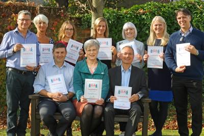 Staff at Norwich Housing Society with their Friends Against Scams certificates