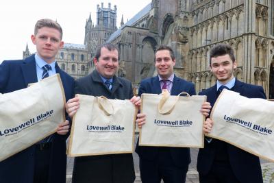 Staff from Lovewell Blakes Ely office show off the new jute bags they are to distribute to clients