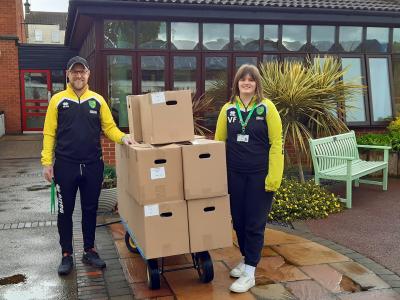 Staff from Norwich Citys Community Sports Foundation deliver food parcels to Vision Norfolks Hammond Court sheltered accommodation sm