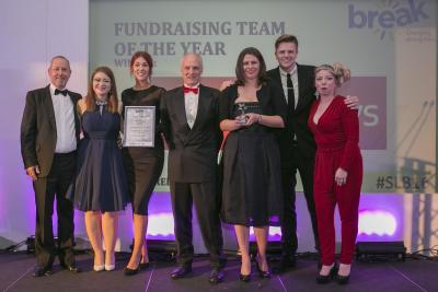 The Arnolds Keys staff charity committee receiving their award from Jake Humphrey