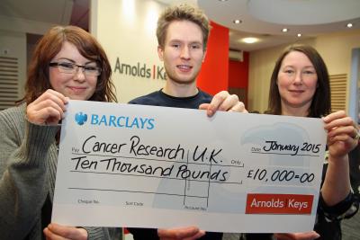 Tom Bamford receives the cheque from Ellie Williamson left and Hiedi Collis of Arnolds Keys