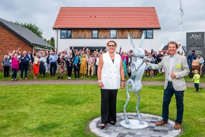 Tony Abel and Cllr Tina Kiddell unveil the dancing hare sculpture at Watton Green sm