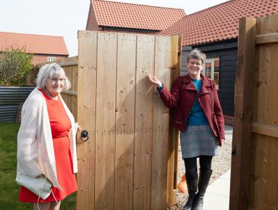 Trunch residents Gillian right and her mum Joan meet at the gate between their two homes by Broadland Housing