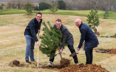 from left Paul LeGrice James Stanley and Mark Burton plant a Scots pine tree at Royal Norwich sm